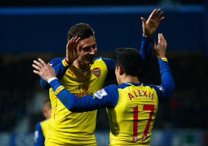 LONDON, ENGLAND - MARCH 04:  Alexis Sanchez of Arsenal (17) celebrates with Olivier Giroud as he scores their second goal during the Barclays Premier League match between Queens Park Rangers and Arsenal at Loftus Road on March 4, 2015 in London, England.  (Photo by Julian Finney/Getty Images)
