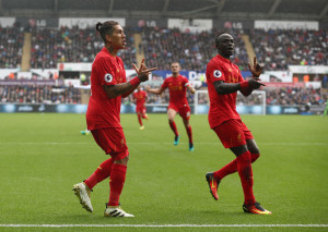 SWANSEA, WALES - OCTOBER 01: Roberto Firmino of Liverpool (L) and Sadio Mane of Liverpool (R) celebrates their sides first goal during the Premier League match between Swansea City and Liverpool at Liberty Stadium on October 1, 2016 in Swansea, Wales.  (Photo by Julian Finney/Getty Images)