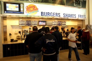 NEW YORK - APRIL 02:  Spectators wait for food at Johnny Rockets during a New York Yankees workout at the new Yankee Stadium on April 2, 2009 in the Bronx borough of New York City.  (Photo by Ezra Shaw/Getty Images)