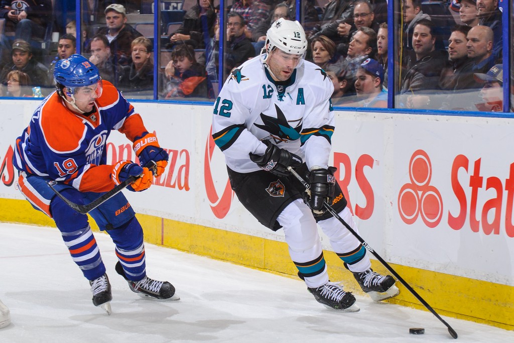 EDMONTON, AB - JANUARY 29: Justin Schultz #19 of the Edmonton Oilers chases Patrick Marleau #12 of the San Jose Sharks during an NHL game at Rexall Place on January 29, 2014 in Edmonton, Alberta, Canada. The Oilers defeated the Sharks 3-0. (Photo by Derek Leung/Getty Images)