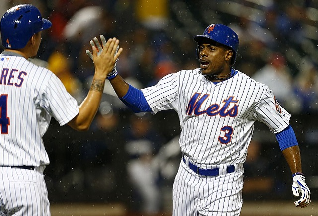 NEW YORK, NY - MAY 16: Curtis Granderson #3 of the New York Mets is congratulated by teammate Wilmer Flores #4 after hitting a two run home run in the seventh inning against the Milwaukee Brewers on May 16, 2015 at Citi Field in the Flushing neighborhood of the Queens borough of New York City. The Mets defeated the Brewers 14-1. (Photo by Rich Schultz/Getty Images)