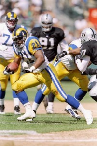 28 Sep 1997:  Running back Lawrence Phillips #21 of the St. Louis Rams carries the football during the Rams 35-17 loss to the Oakland Raiders at UMAX Stadium in Oakland, California. Mandatory Credit: Todd Warshaw  /Allsport
