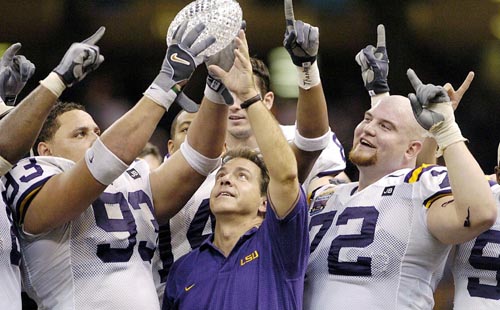Louisiana State head coach Nick Saban (C) celebrates winning the College Football National Championship with players Chad Lavlais (L), Stephen Peterman (R) and the rest of the LSU Tigers after beating the Oklahoma Sooners in the Nokia Sugar Bowl game in New Orleans, Louisiana, on Sunday, 04 January 2004. The Tigers beat the Sooners 21-14.  EPA/RHONA WISE