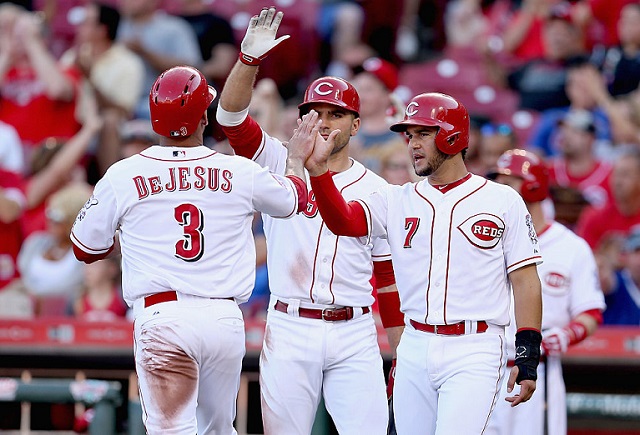 CINCINNATI, OH - JULY 22: Ivan de Jesus #3 of the Cincinnati Reds is congratulated by Eugenio Suarez #7 after scoring in the second inning against the Chicago Cubs during the second game of a doubleheader at Great American Ball Park on July 22, 2015 in Cincinnati, Ohio. (Photo by Andy Lyons/Getty Images)