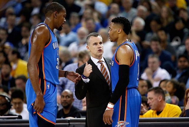 MARCH 03: Kevin Durant #35 and Russell Westbrook #0 of the Oklahoma City Thunder talk to head coach Billy Donovan during their game against the Golden State Warriors at ORACLE Arena on March 3, 2016 in Oakland, California. (Photo by Ezra Shaw/Getty Images)