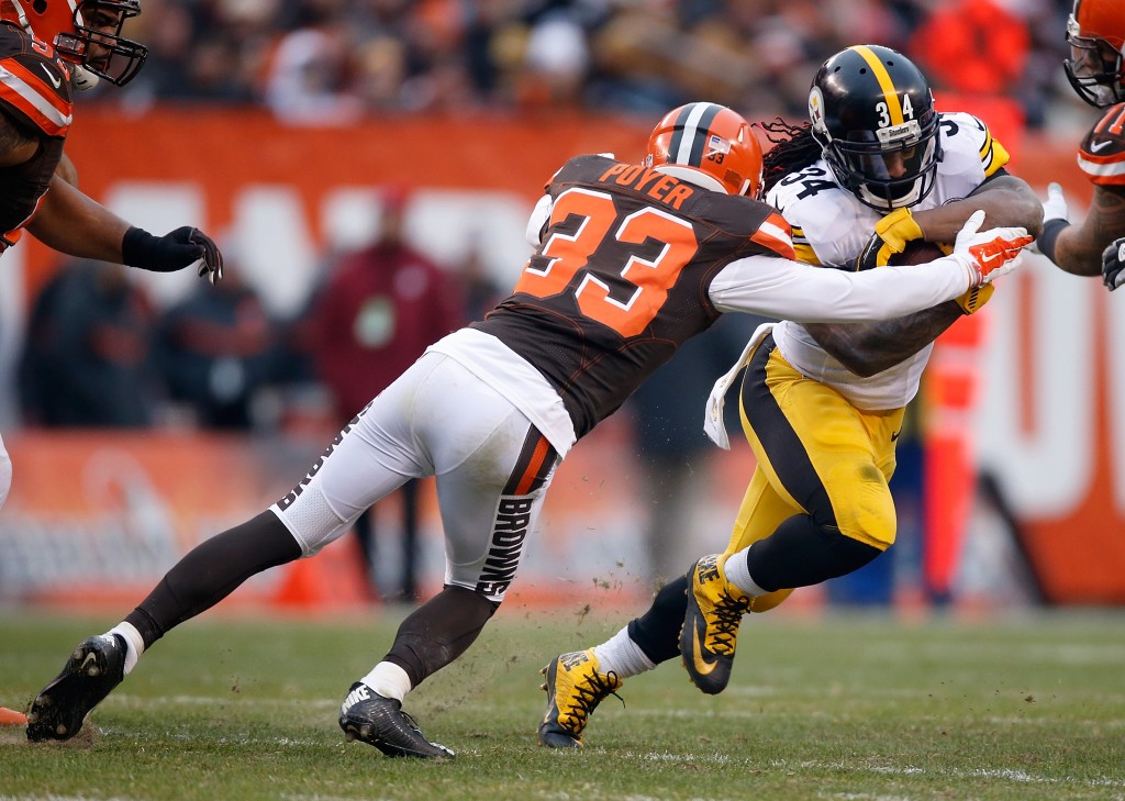 CLEVELAND, OH - JANUARY 3:  DeAngelo Williams #34 of the Pittsburgh Steelers gets wrapped up by Jordan Poyer #33 of the Cleveland Browns during the second quarter at FirstEnergy Stadium on January 3, 2016 in Cleveland, Ohio.  (Photo by Gregory Shamus/Getty Images)