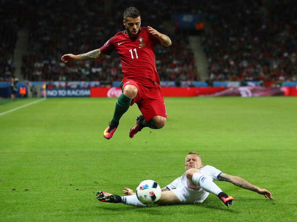 SAINT-ETIENNE, FRANCE - JUNE 14:  Vieirinha of Portugal is tackled by Ari Skulason of Iceland during the UEFA EURO 2016 Group F match between Portugal and Iceland at Stade Geoffroy-Guichard on June 14, 2016 in Saint-Etienne, France.  (Photo by Julian Finney/Getty Images)