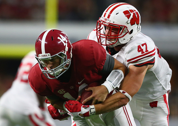 ARLINGTON, TX - SEPTEMBER 05:  Vince Biegel #47 of the Wisconsin Badgers tackles Jake Coker #14 of the Alabama Crimson Tide during the Advocare Classic at AT&T Stadium on September 5, 2015 in Arlington, Texas.  (Photo by Ronald Martinez/Getty Images)