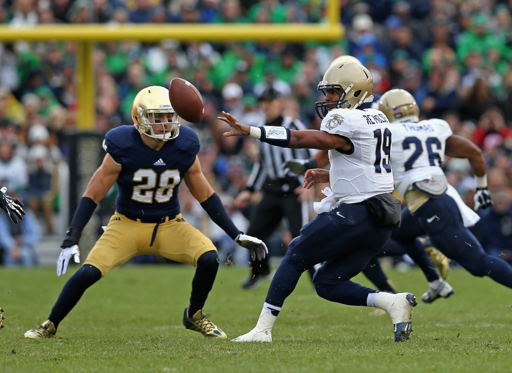 SOUTH BEND, IN - NOVEMBER 02: Keenan Reynolds #19 of the Navy Midshipmen pitches the ball in front of Austin Collinsworth #28 of the Notre Dame Fighting Irish at Notre Dame Stadium on November 2, 2013 in South Bend, Indiana. Notre Dame defeated Navy 38-34. (Photo by Jonathan Daniel/Getty Images)