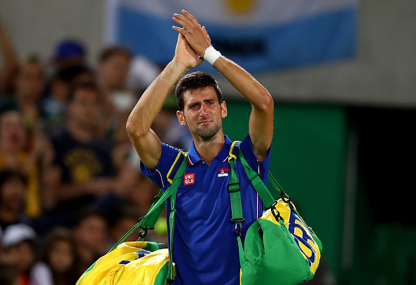 RIO DE JANEIRO, BRAZIL - AUGUST 07:  Novak Djokovic of Serbia shows his emotion as he waves to the crowd after his defeat against Juan Martin Del Potro of Argentina in their singles match on Day 2 of the Rio 2016 Olympic Games at the Olympic Tennis Centre on August 7, 2016 in Rio de Janeiro, Brazil.  (Photo by Clive Brunskill/Getty Images)