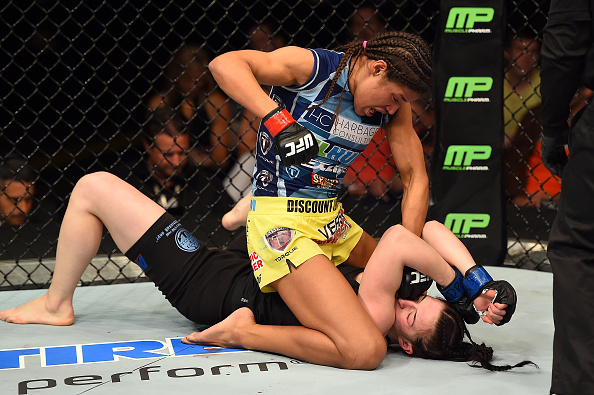 FAIRFAX, VA - APRIL 04:  (L-R) Juliana Pena punches Milana Dudieva on the ground in their women's bantamweight fight during the UFC Fight Night event at the Patriot Center on April 4, 2015 in Fairfax, Virginia. (Photo by Josh Hedges/Zuffa LLC/Zuffa LLC via Getty Images)
