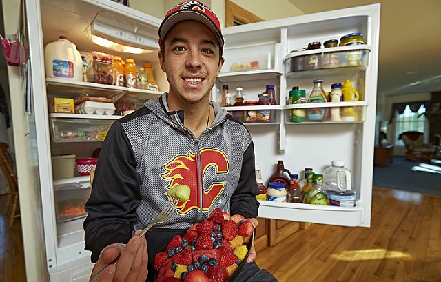Casual portrait of Calgary Flames forward Johnny Gaudreau posing with fruit salad in front of his open refrigerator during photo shoot in his home. The lightest player in the NHL at 157 pounds, Gaudreau maintains a high protein diet to keep weight on. Carneys Point, NJ 8/22/2016 (Photo by Al Tielemans /Sports Illustrated/Getty Images) (Set Number: SI519 TK1 )