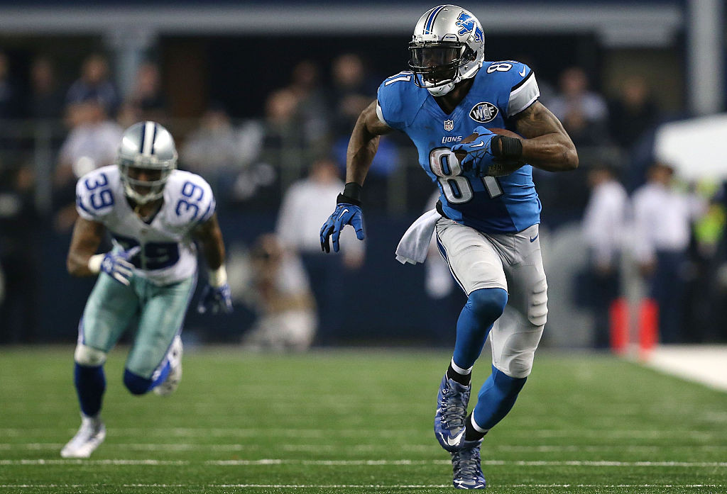 ARLINGTON, TX - JANUARY 04:  Calvin Johnson #81 of the Detroit Lions runs with the ball as Brandon Carr #39 of the Dallas Cowboys gives chase during the second half of their NFC Wild Card Playoff game at AT&T Stadium on January 4, 2015 in Arlington, Texas.  (Photo by Sarah Glenn/Getty Images)