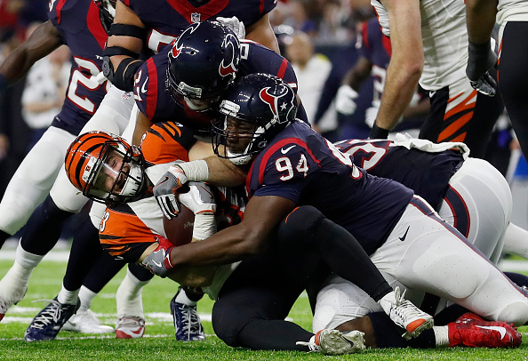 HOUSTON, TX - DECEMBER 24: Rex Burkhead #33 of the Cincinnati Bengals is tackled by Antonio Smith #94 of the Houston Texans in the fourth quarter at NRG Stadium on December 24, 2016 in Houston, Texas. (Photo by Tim Warner/Getty Images)