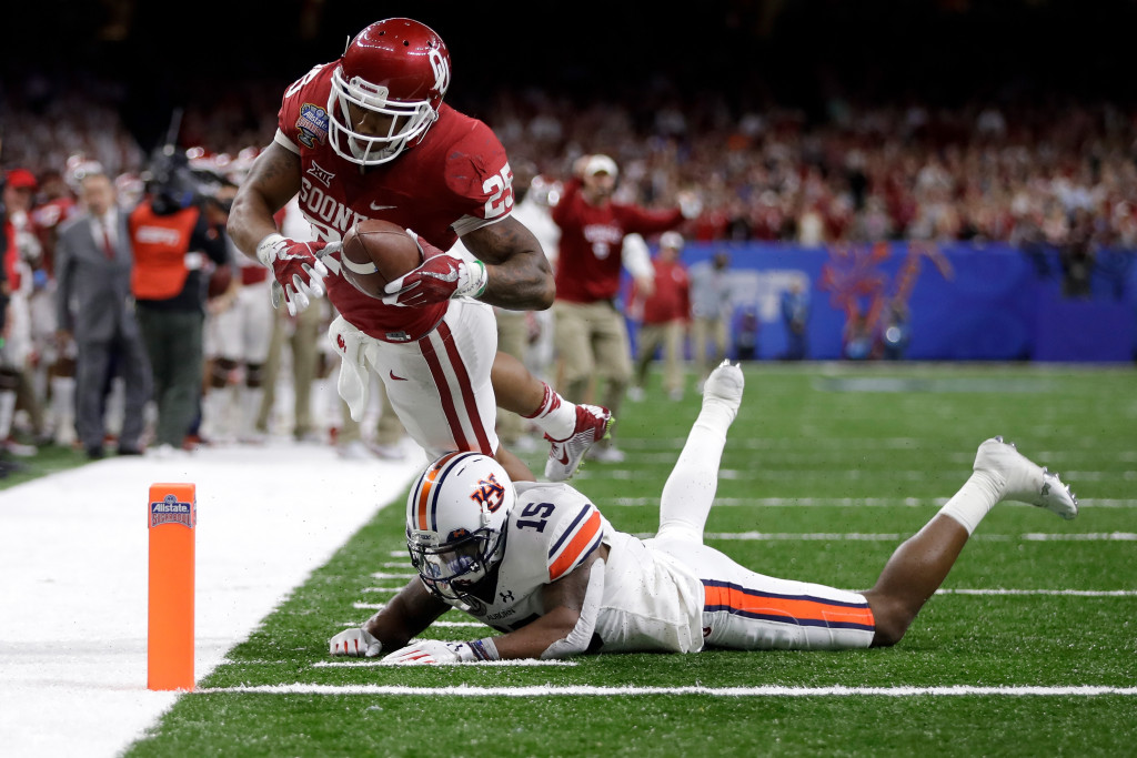 NEW ORLEANS, LA - JANUARY 02:  Joe Mixon #25 of the Oklahoma Sooners scores a touchdown over Joshua Holsey #15 of the Auburn Tigers during the Allstate Sugar Bowl at the Mercedes-Benz Superdome on January 2, 2017 in New Orleans, Louisiana.  (Photo by Sean Gardner/Getty Images)