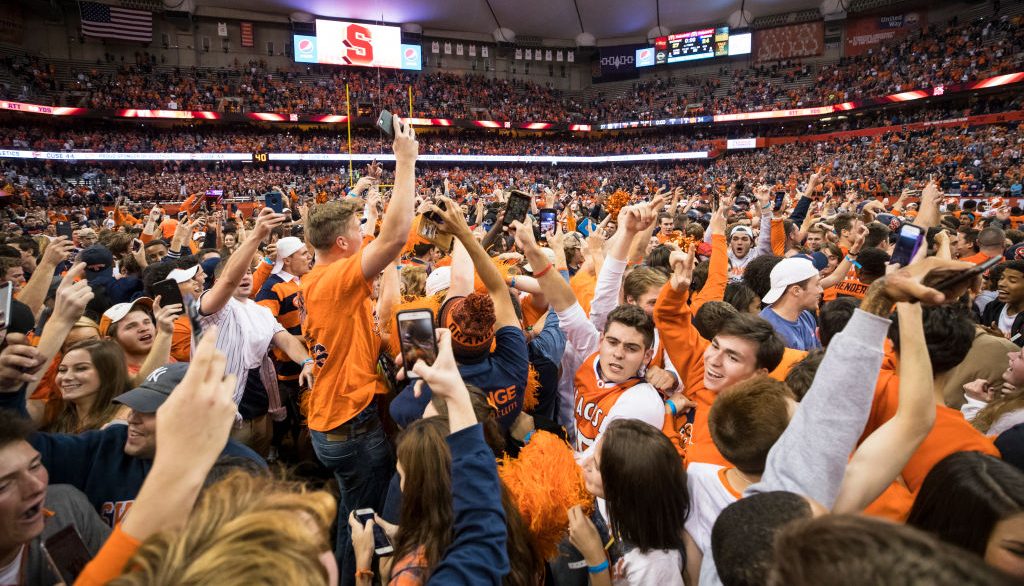 SYRACUSE, NY - OCTOBER 13: Syracuse Orange fans storm the field after the team upset Clemson Tigers at the Carrier Dome on October 13, 2017 in Syracuse, New York. Syracuse defeats Clemson 27-24.