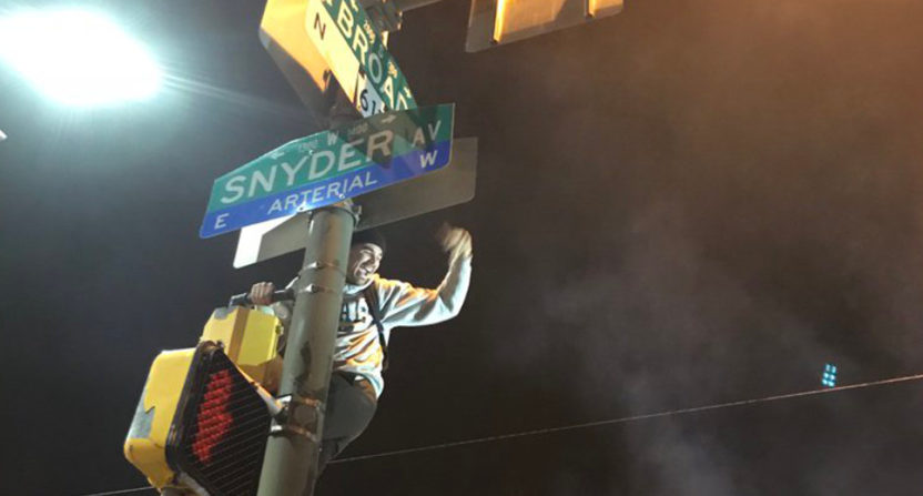 Post-game celebrations in Philly included this fan climbing a pole.