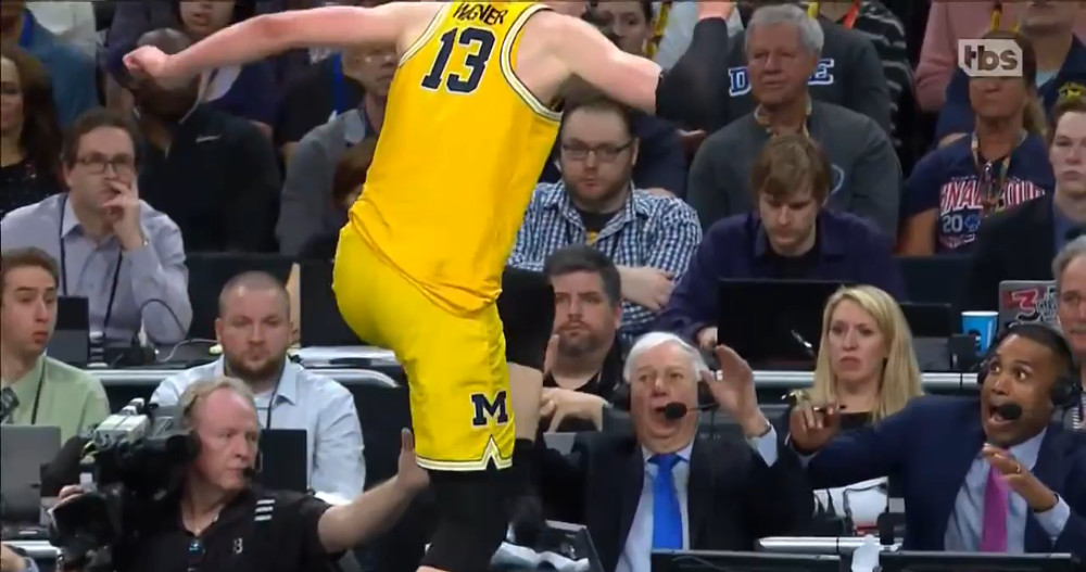 Moritz Wagner leaps onto the TBS announcing table in front of Bill Raftery and Grant Hill.