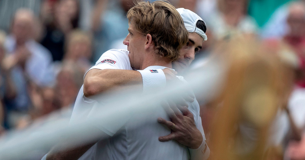 John Isner (in hat) hugs Kevin Anderson after a Wimbledon loss.