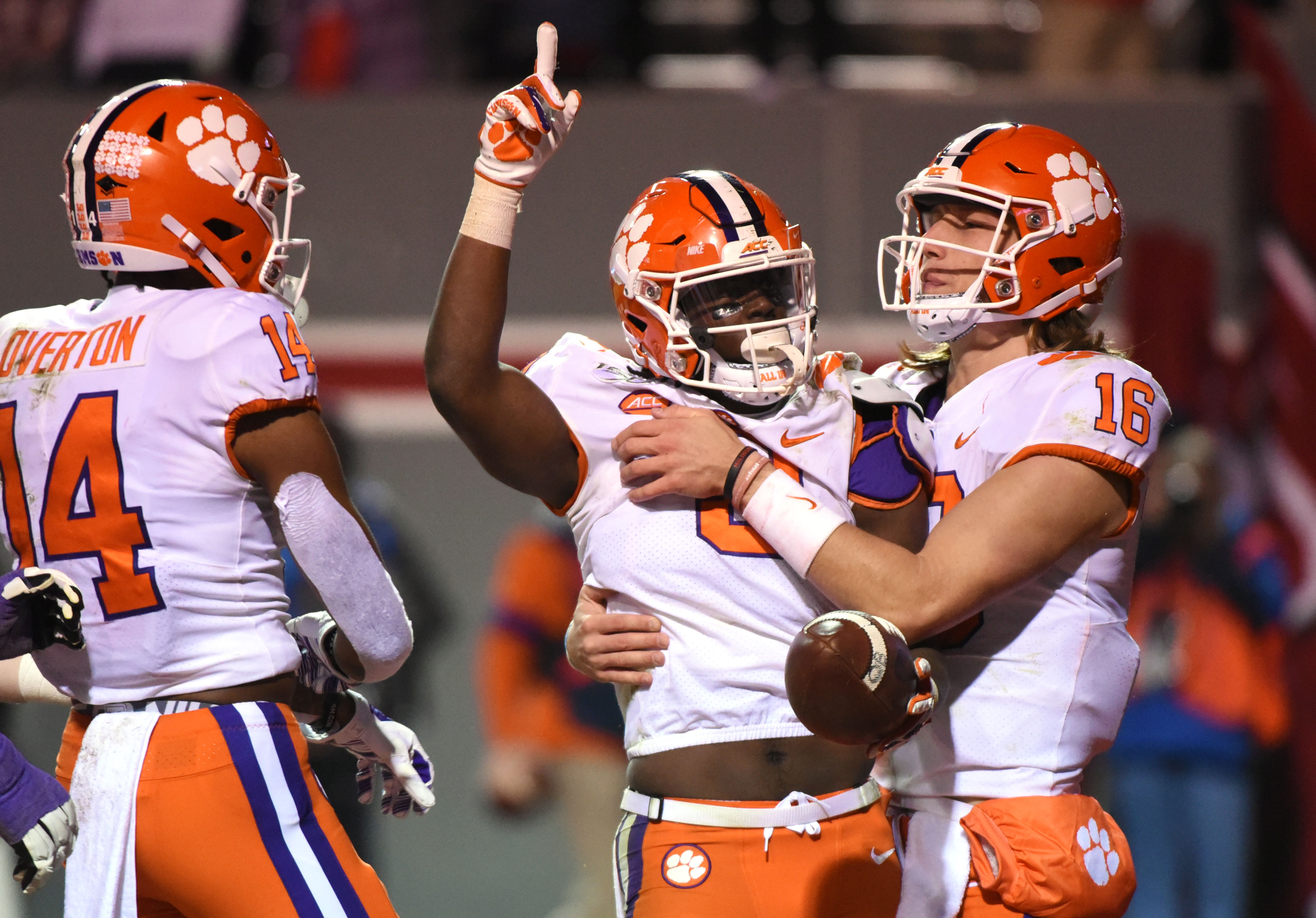 Clemson Tigers running back Travis Etienne (9) celebrates his third touchdown with quarterback Trevor Lawrence (16) during the second half against the North Carolina State Wolfpack at Carter-Finley Stadium. Credit: Rob Kinnan-USA TODAY Sports