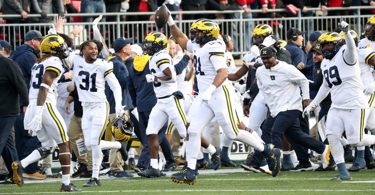 The Michigan Wolverines celebrate an interception by Taylor Upshaw (91) against Ohio State.