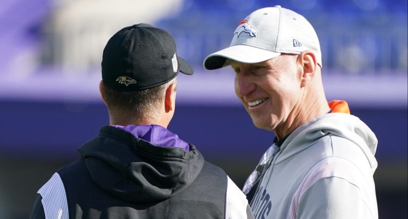 Baltimore Ravens head coach John Harbaugh (left) talks with Denver Broncos coach Jerry Rosburg