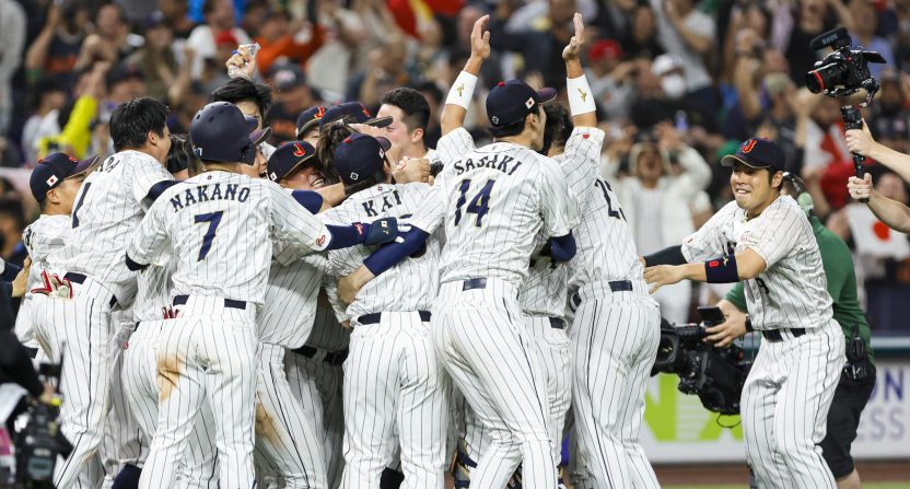 Team Japan celebrates on the field after winning the game with a walk-off double from Japan third base Munetaka Murakami