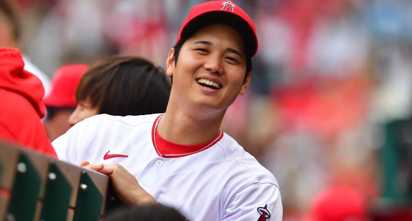 Los Angeles Angeles superstar Shohei Ohtani smiles in the dugout.