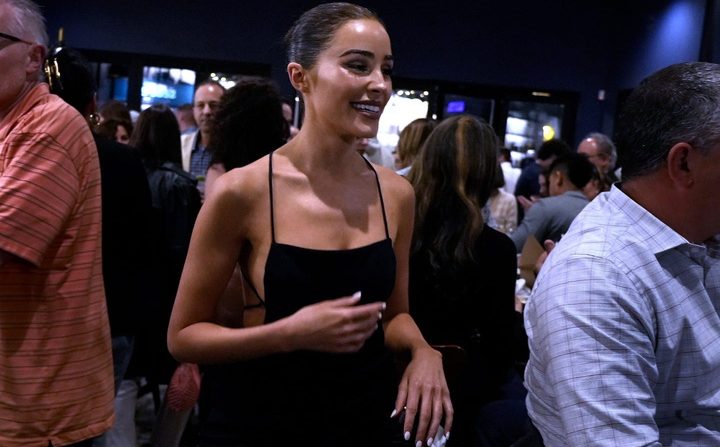Olivia Culpo attends Tuesday's opening of her second restaurant with her family.