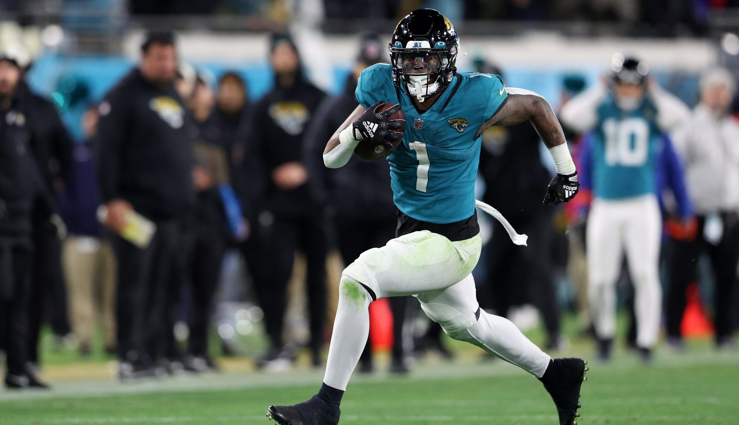 Jaguars running back Travis Etienne Jr. (1) runs during the fourth quarter of a wild card game against the Los Angeles Chargers at TIAA Bank Field.