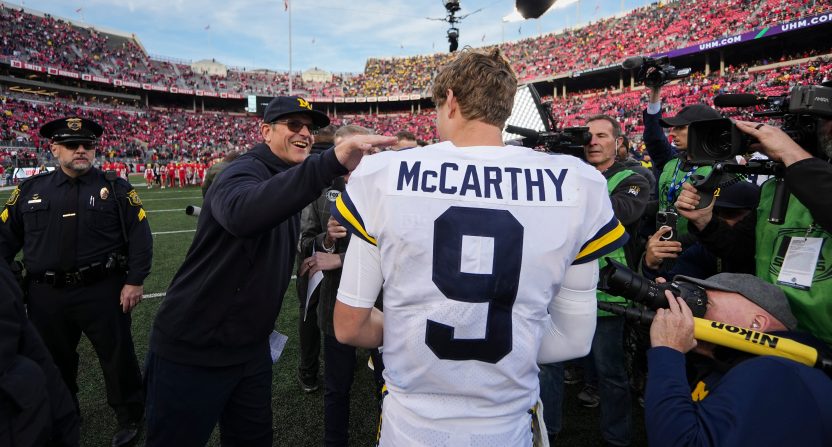 Michigan Wolverines head coach Jim Harbaugh congratulates Michigan Wolverines quarterback J.J. McCarthy