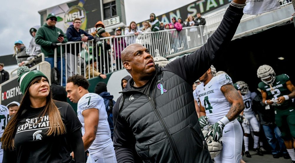 Michigan State's head coach Mel Tucker, right, hands back a signed football for fans on Saturday, April 16, 2022, during the spring game at Spartan Stadium in East Lansing. At left is honorary caption Brenda Tracy, sexual violence prevention educator.