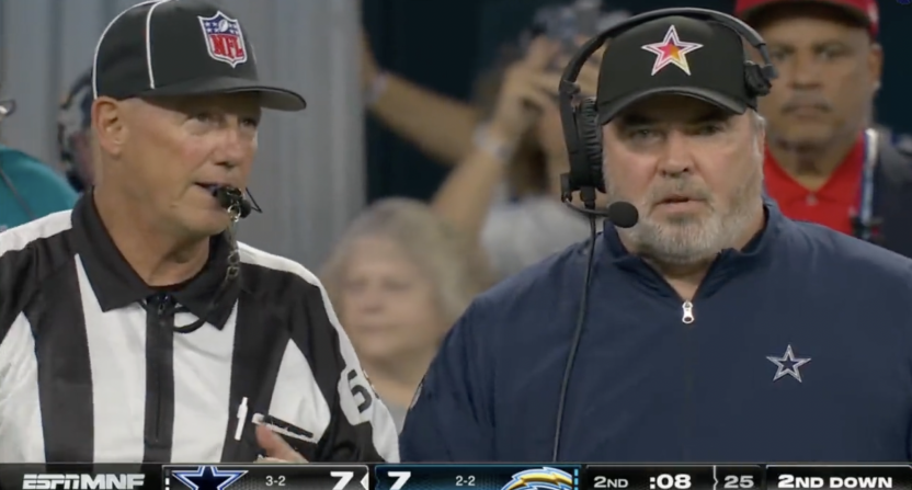 Cowboys head coach Mike McCarthy alongside a referee at the end of the first half of their game against the Chargers.
