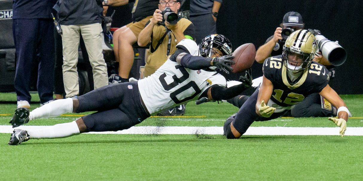 Oct 19, 2023; New Orleans, Louisiana, USA; Jacksonville Jaguars cornerback Montaric Brown (30) knocks the ball away from New Orleans Saints wide receiver Chris Olave (12) during the fourth quarter at the Caesars Superdome. Mandatory Credit: Matthew Hinton-USA TODAY Sports