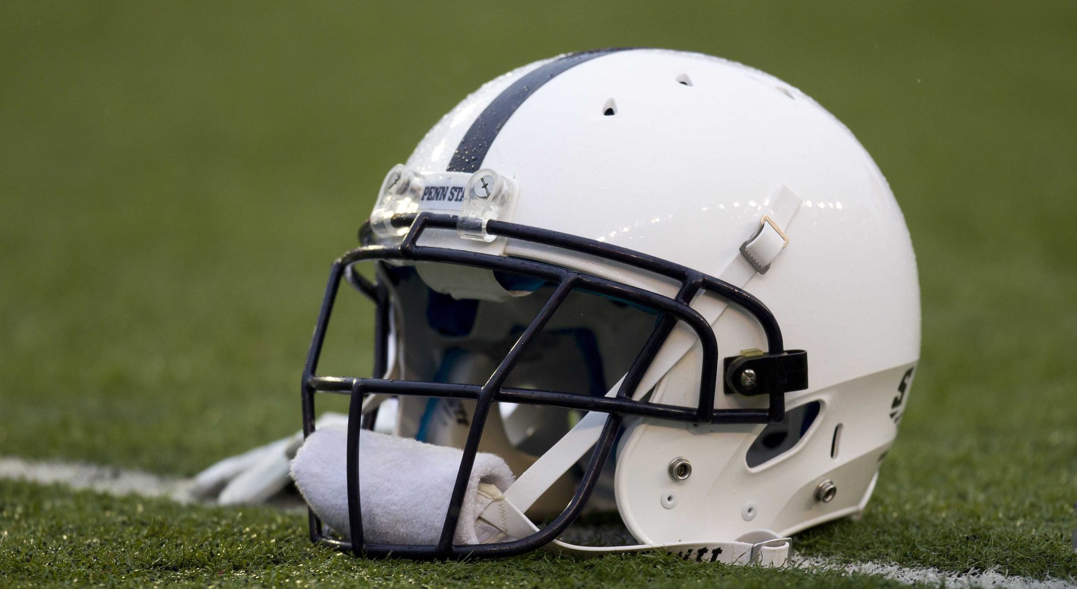 An Penn State Nittany Lions helmet sits on the field during warmups