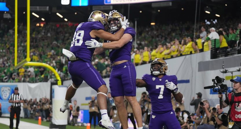 Washington Huskies tight end Quentin Moore (88) celebrates with tight end Jack Westover (37) and running back Dillon Johnson (7) after scoring on a 2-yard touchdown run against the Oregon Ducks in the second half of the Pac-12 Championship game at Allegiant Stadium.