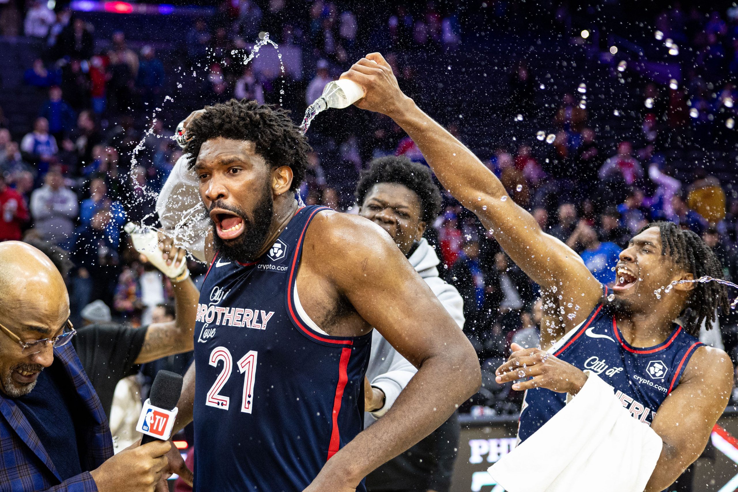 Joel Embed celebrating with 76ers teammates after 70-point performance.