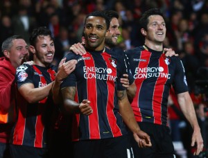 BOURNEMOUTH, ENGLAND - APRIL 27:  Callum Wilson of Bournemouth celebrates with team mates as he scores their third goal during the Sky Bet Championship match between AFC Bournemouth and Bolton Wanderers at Goldsands Stadium on April 27, 2015 in Bournemouth, England.  (Photo by Charlie Crowhurst/Getty Images)