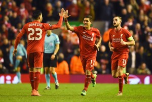 LIVERPOOL, ENGLAND - MARCH 10:  Roberto Firmino of Liverpool (11) celebrates with Emre Can (23) as he scores their second goal during the UEFA Europa League Round of 16 first leg match between Liverpool and Manchester United at Anfield on March 10, 2016 in Liverpool, United Kingdom.  (Photo by Laurence Griffiths/Getty Images)