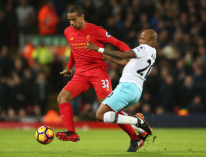 LIVERPOOL, ENGLAND - DECEMBER 11: Joel Matip of Liverpool and Andre Ayew of West Ham United compete for the ball during the Premier League match between Liverpool and West Ham United at Anfield on December 11, 2016 in Liverpool, England.  (Photo by Jan Kruger/Getty Images)