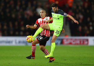 SOUTHAMPTON, ENGLAND - JANUARY 11: Adam Lallana of Liverpool beats Oriol Romeu of Southampton ot the ball during the EFL Cup semi-final first leg match between Southampton and Liverpool at St Mary's Stadium on January 11, 2017 in Southampton, England. (Photo by Clive Rose/Getty Images)