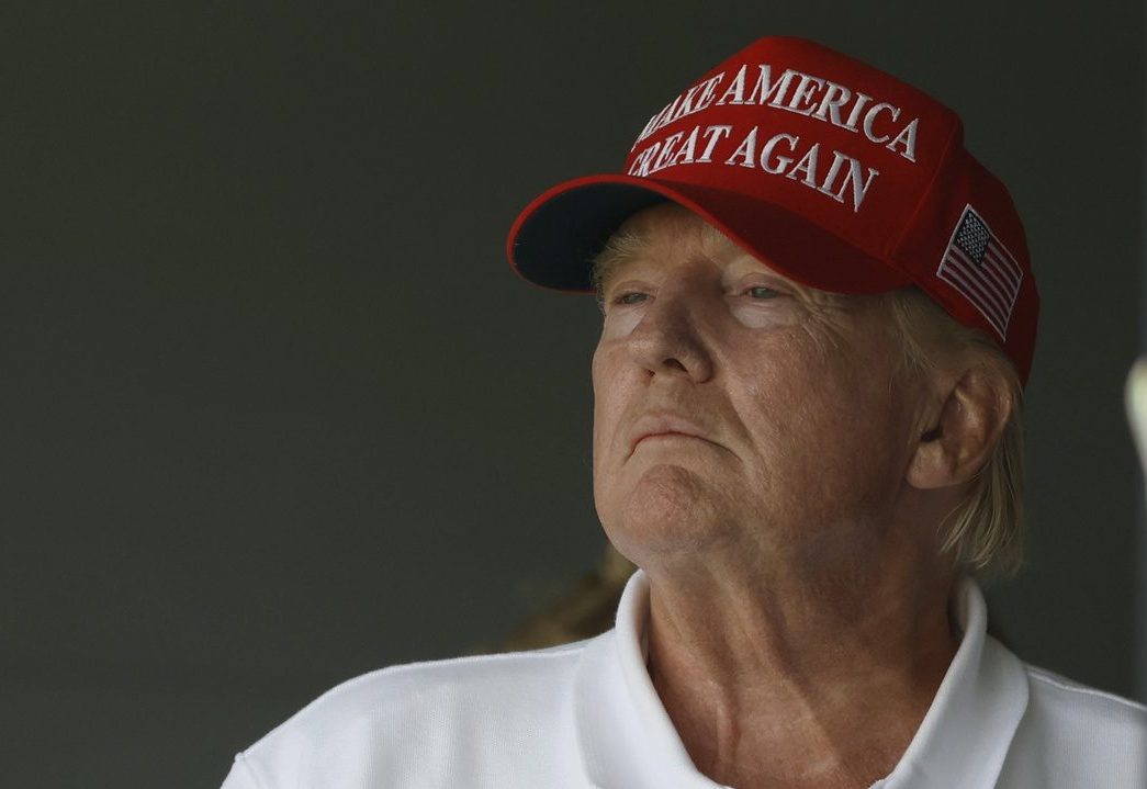 Former President Donald Trump watches from a hospitality suite on the eighteenth green during the second round of LIV Golf Washington, D.C. golf tournament