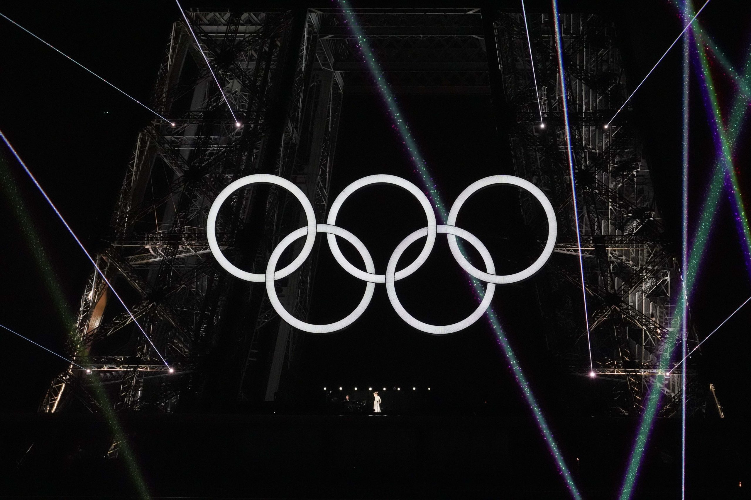 Jul 26, 2024; Paris, FRANCE; Celine Dion performs under the Olympic rings during the Opening Ceremony for the Paris 2024 Olympic Summer Games along the Seine River. Mandatory Credit: James Lang-USA TODAY Sports