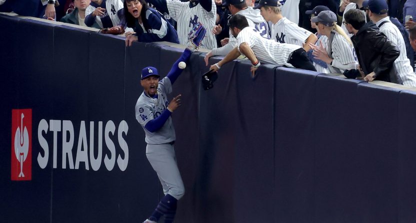 Los Angeles Dodgers star Mookie Betts is interfered with by a New York Yankees fan during Game 4 of the World Series at Yankee Stadium.