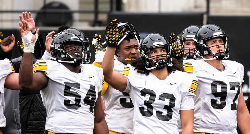 Iowa Hawkeyes football players wave to patients in the Stead Family Children's Hospital.