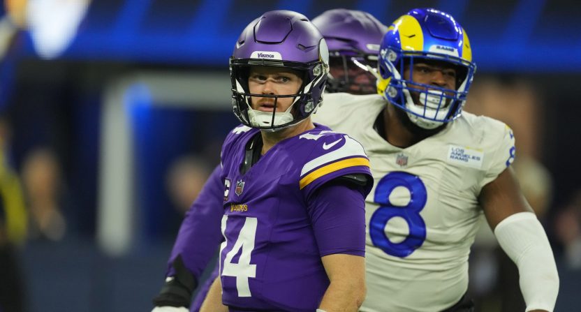 Minnesota Vikings quarterback Sam Darnold and Los Angeles Rams edge rusher Jared Verse during an NFL game at SoFi Stadium.