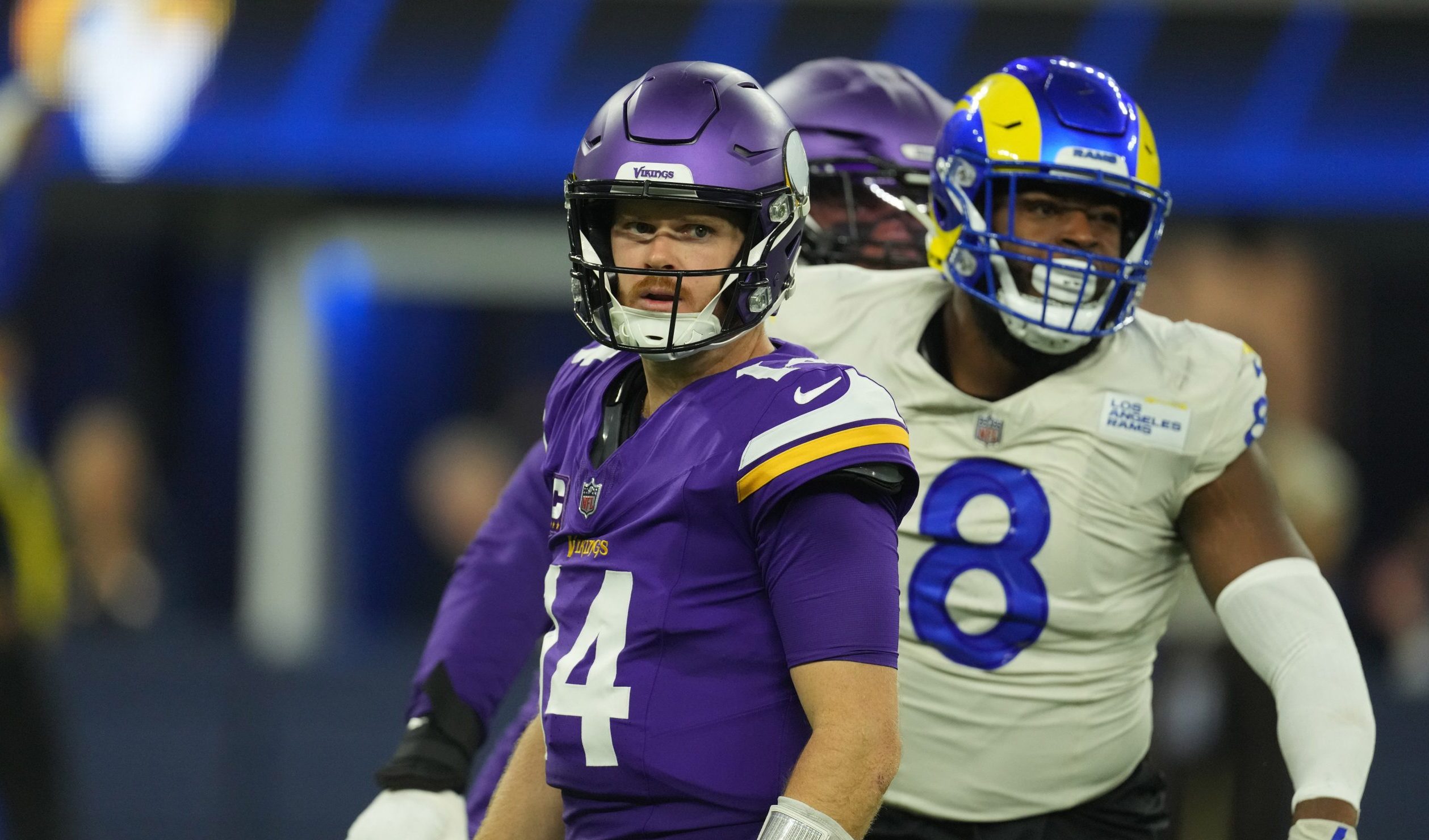 Minnesota Vikings quarterback Sam Darnold and Los Angeles Rams edge rusher Jared Verse during an NFL game at SoFi Stadium.