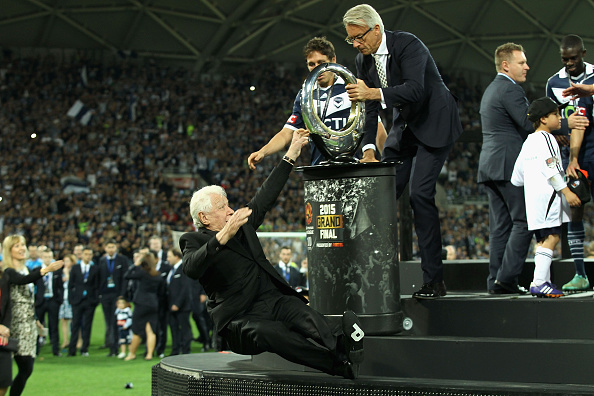 MELBOURNE, AUSTRALIA - MAY 17:  FFA chairman Frank Lowy falls off the stage as he presents Victory with the winners trophy during the 2015 A-League Grand Final match between the Melbourne Victory and Sydney FC at AAMI Park on May 17, 2015 in Melbourne, Australia.  (Photo by Robert Prezioso/Getty Images)