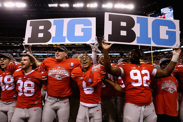 INDIANAPOLIS, IN - DECEMBER 06:  Evan Spencer #6, Adolphus Washington #92 and the Ohio State Buckeyes celebrate after they defeated the Wisconsin Badgers 59-0 in the Big Ten Championship at Lucas Oil Stadium on December 6, 2014 in Indianapolis, Indiana.  (Photo by Andy Lyons/Getty Images)