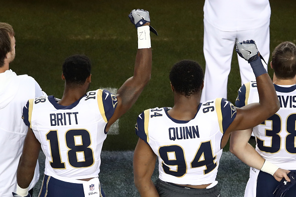 SANTA CLARA, CA - SEPTEMBER 12:  Kenny Britt #18 and Robert Quinn #94 of the Los Angeles Rams raise their fists in protest prior to playing the San Francisco 49ers in their NFL game at Levi's Stadium on September 12, 2016 in Santa Clara, California.  (Photo by Ezra Shaw/Getty Images)